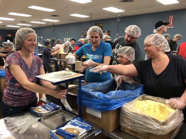 volunteering packing meals at FMSC