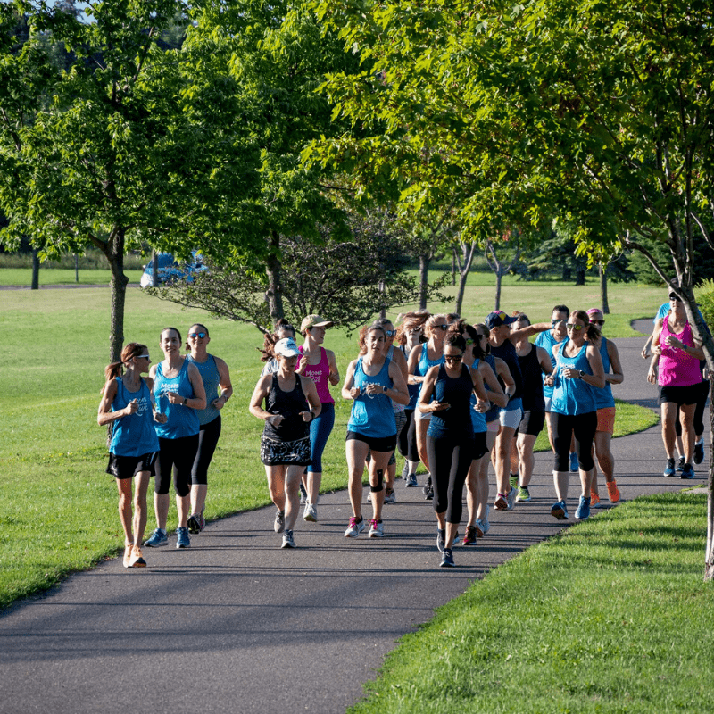 Group of 20+ MOTR members running on a park path